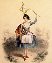 Sur un fond de couleur sépia et devant un paysage estompé, la danseuse est représentée debout, main droite à la taille, et tenant de la gauche un étendard au-dessus de sa tête. Elle porte un chapeau noir en forme de galette, à rubans de couleurs, incliné sur ses cheveux foncés, une robe bleu-gris au corsage lacé et fortement échancré, à manches longues boutonnées aux poignets, à la jupe ample arrêtée à hauteur des genoux et recouverte d’un tablier blanc. Quelques fleurs à la lisière du béret, un mantelet à passementerie posé sur l’épaule droite, des chaussures montantes mais sans talon, un ruban repliant partiellement le tablier ajoutent leur note de rouge et égaient l’ensemble.