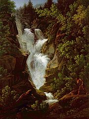 Tableau d'une chute d'eau en fureur entourée par des arbres verts luxuriants, et par des rochers bruns.